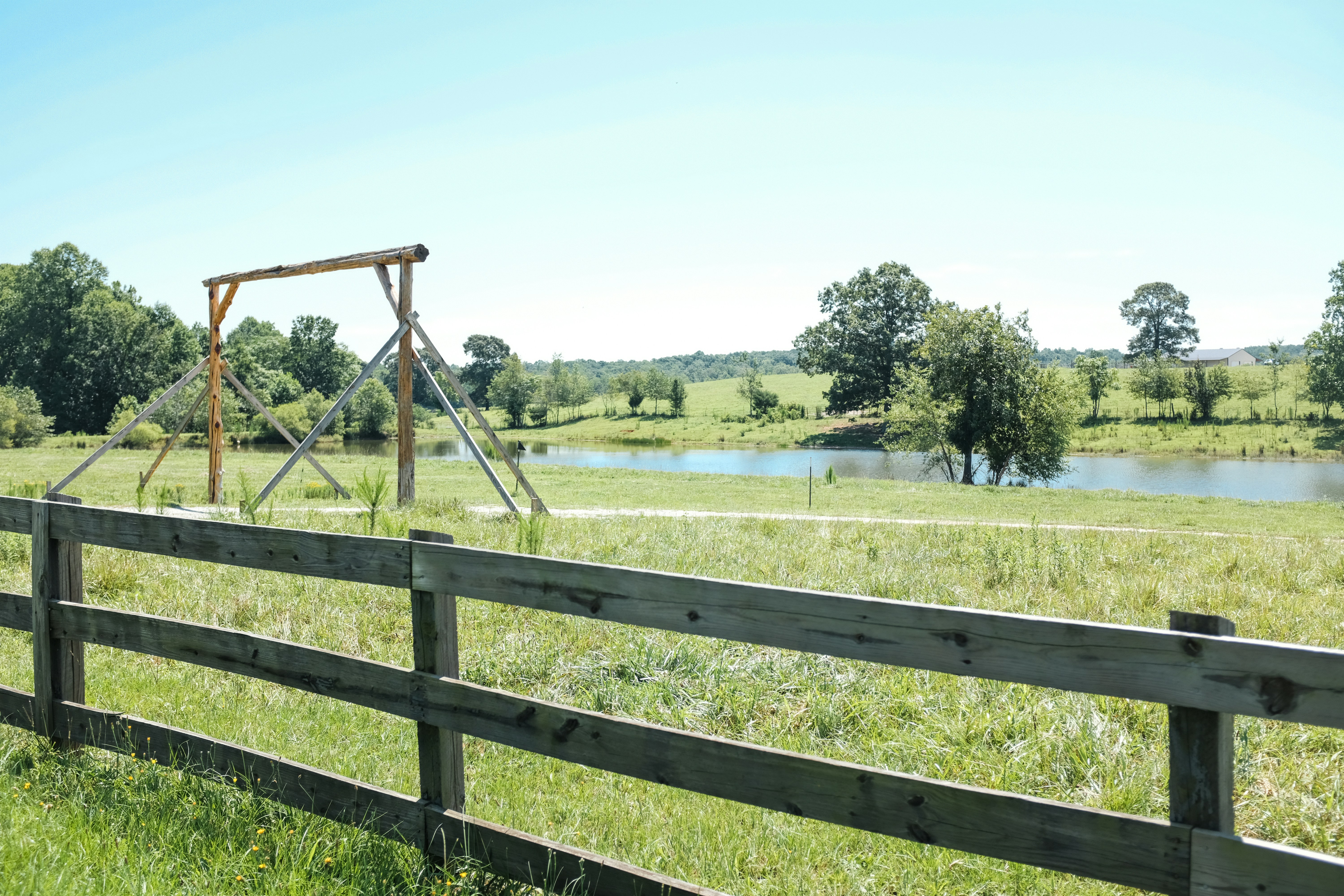 brown wooden fence on green grass field during daytime