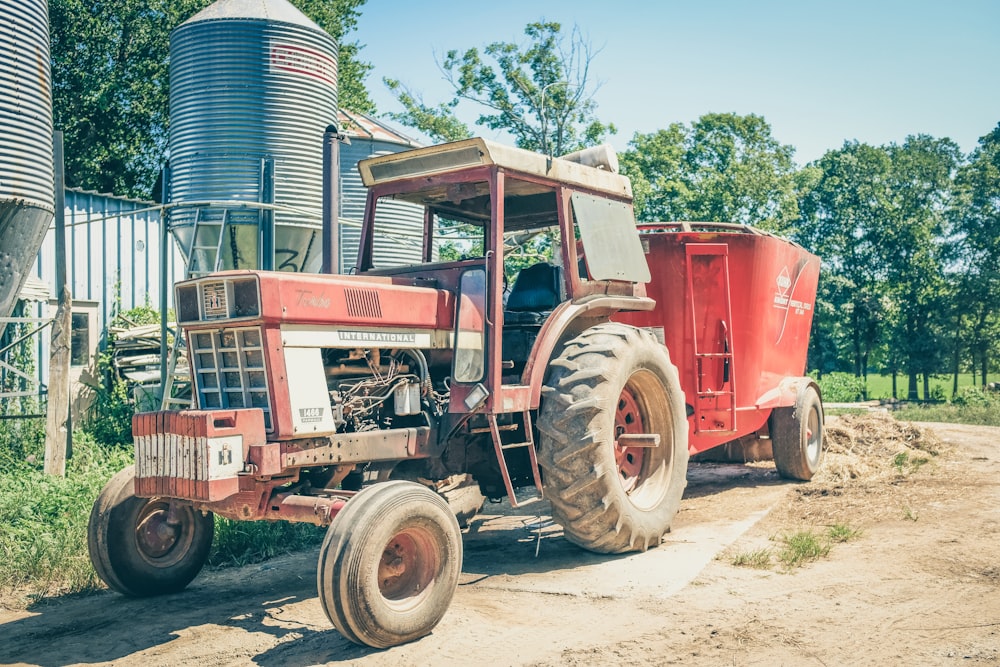 red tractor on brown dirt during daytime