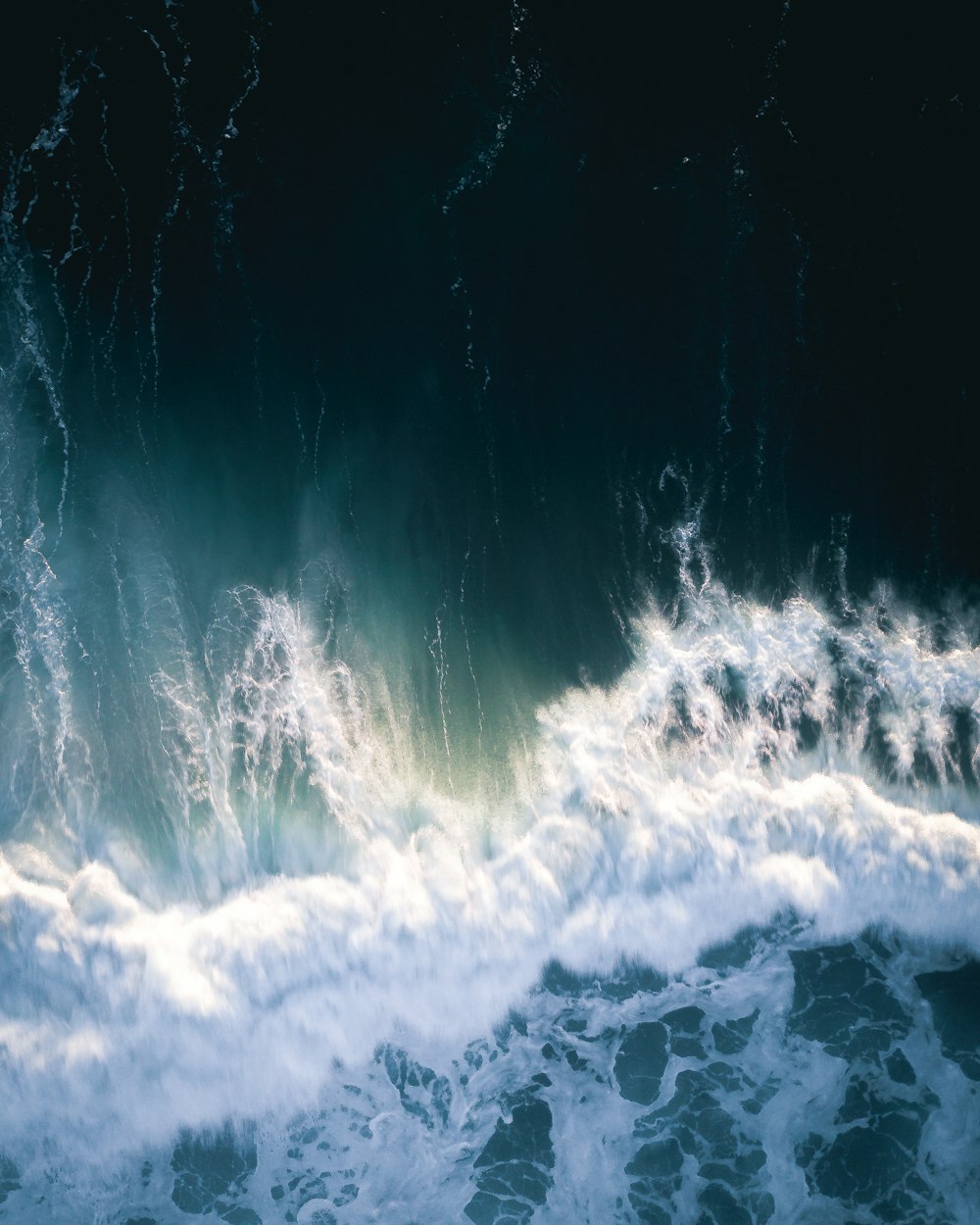 water waves hitting rocks during daytime