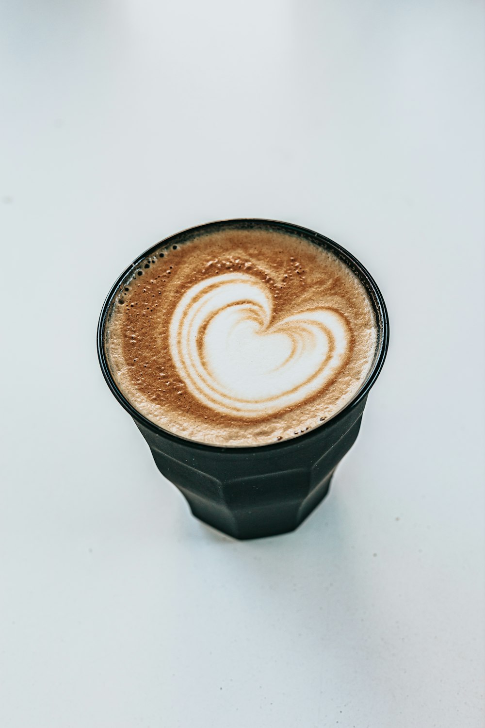 black and white ceramic mug with heart shaped coffee