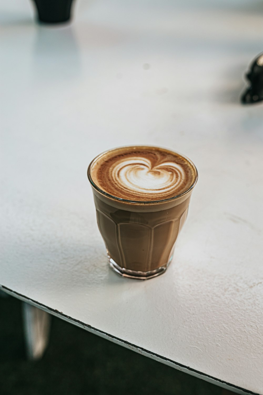 brown and white coffee cup