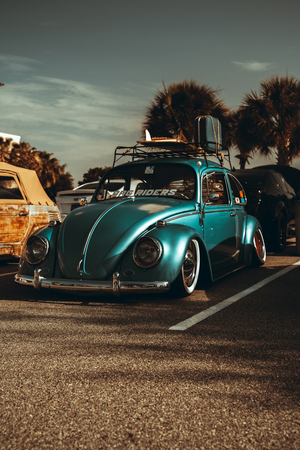 blue and white vintage car on road during daytime