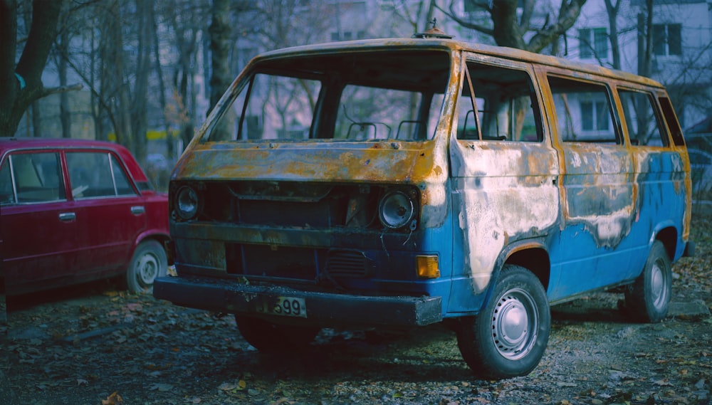 blue and white van on gray asphalt road during daytime