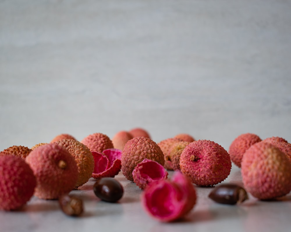 brown and pink round fruit on white table