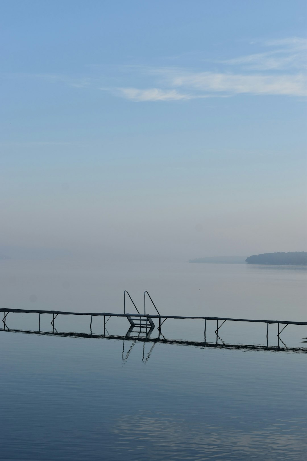 black metal railings on sea during daytime