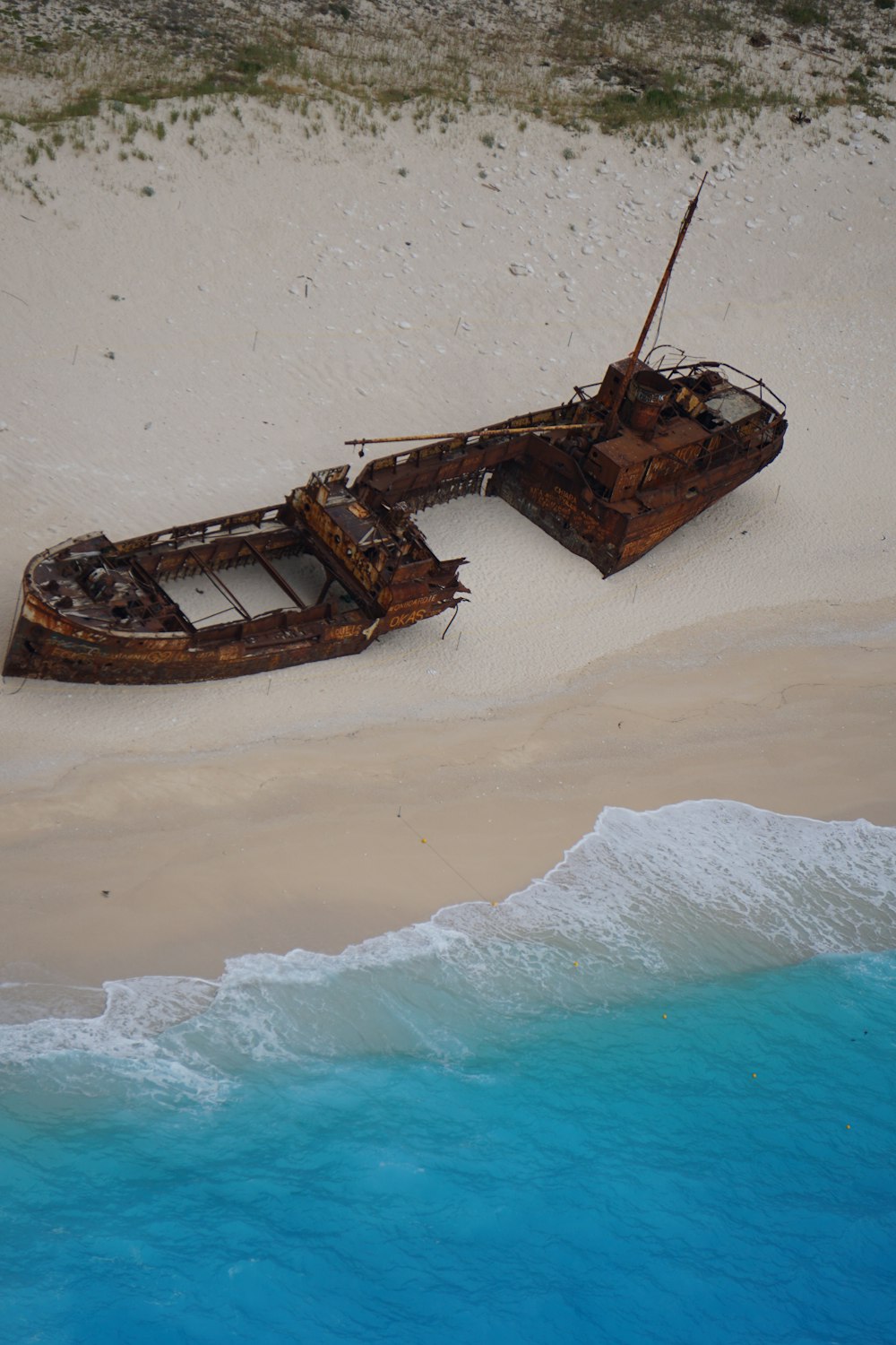 brown and white boat on sea shore during daytime