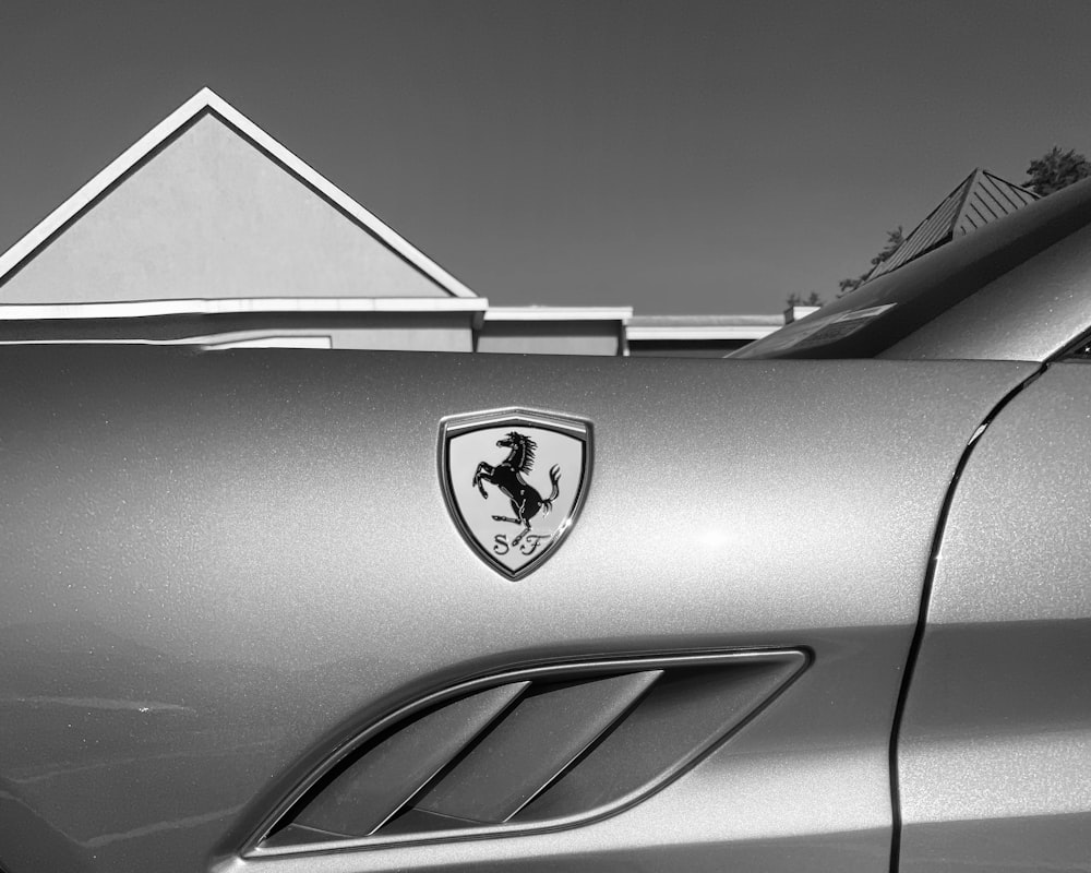 grayscale photo of car with logo