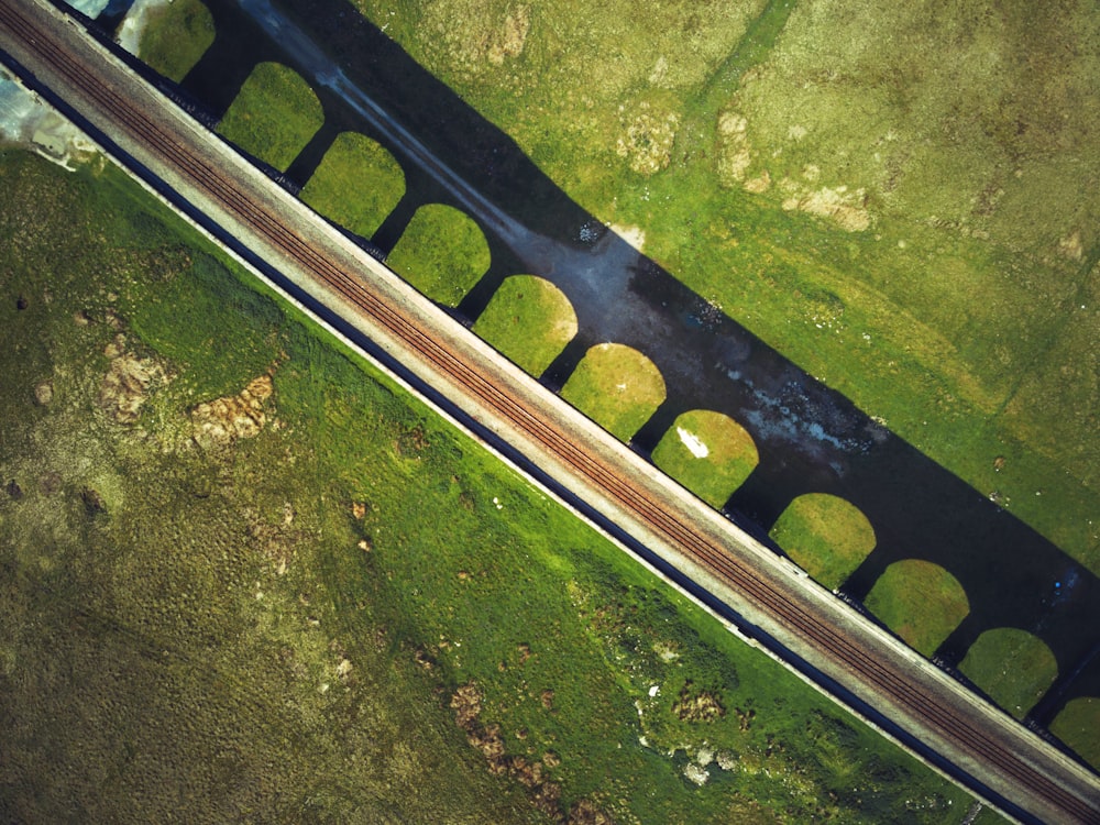 gray metal railings on green grass field