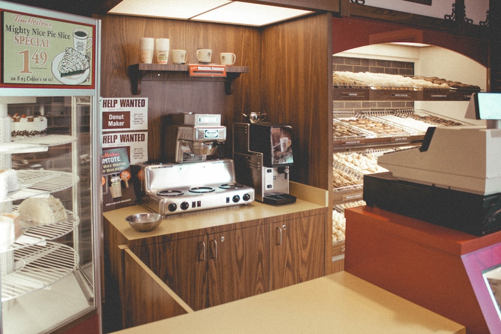 silver and black coffee maker on brown wooden counter