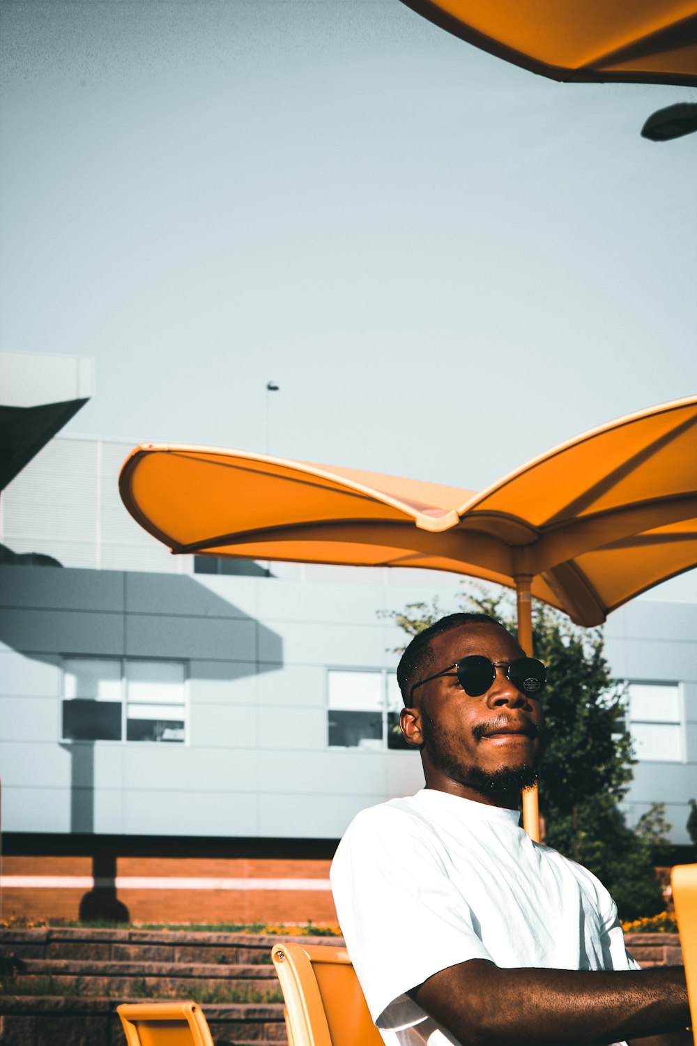 man in white shirt wearing sunglasses