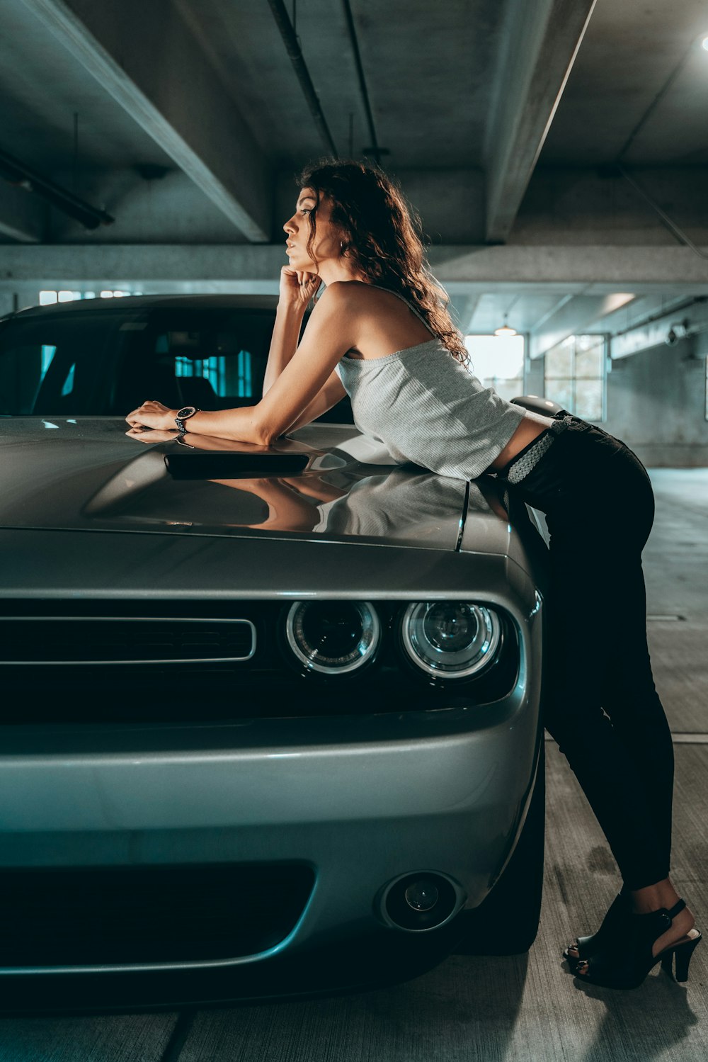 woman in white dress sitting on car hood during daytime