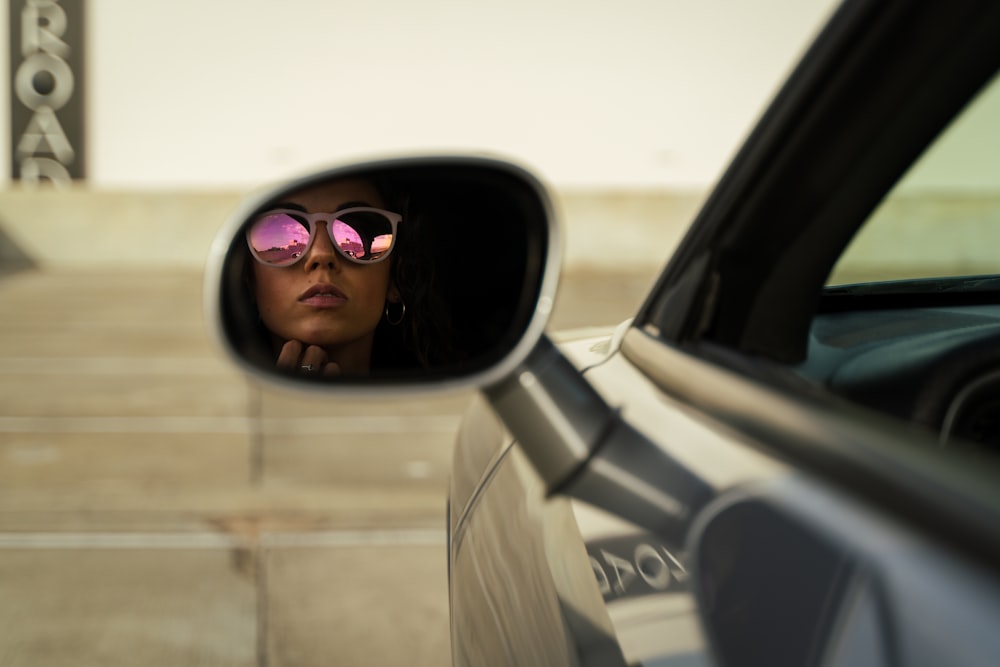 woman in white coat wearing sunglasses