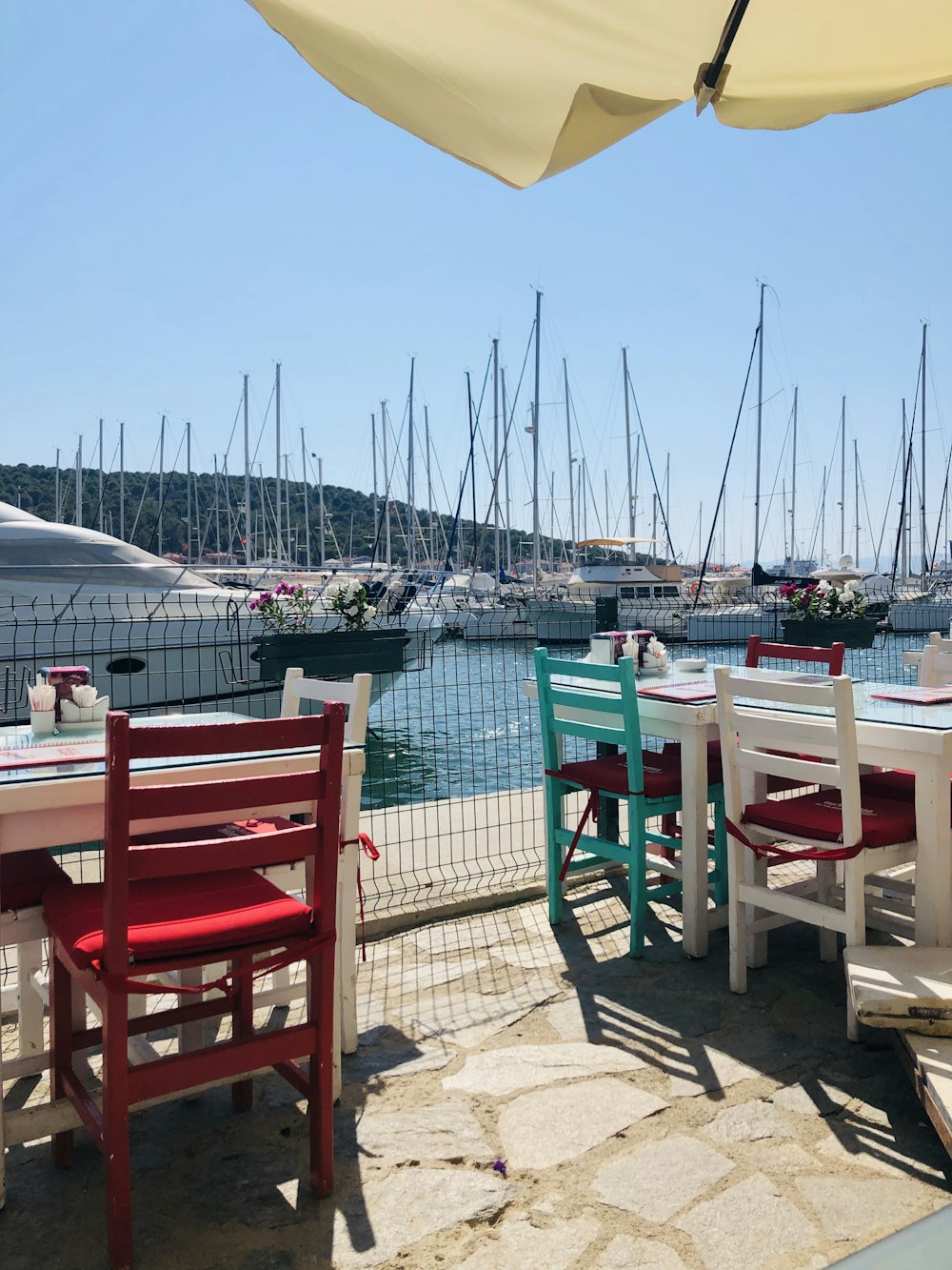 red wooden chair near body of water during daytime