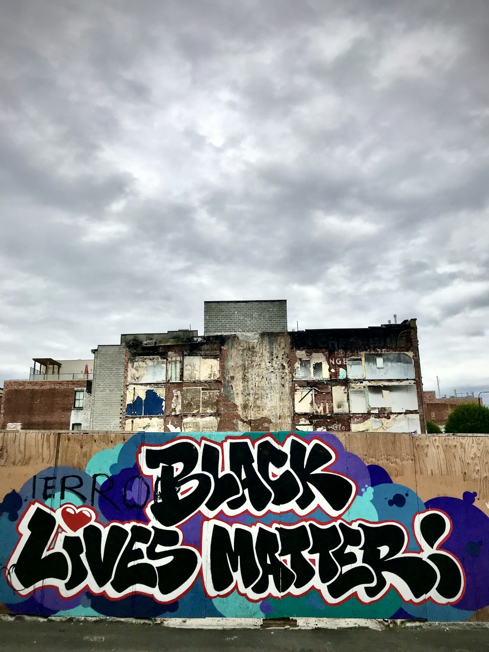 purple and blue graffiti on wall