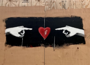 A close-up of hands holding a heart-shaped symbol.