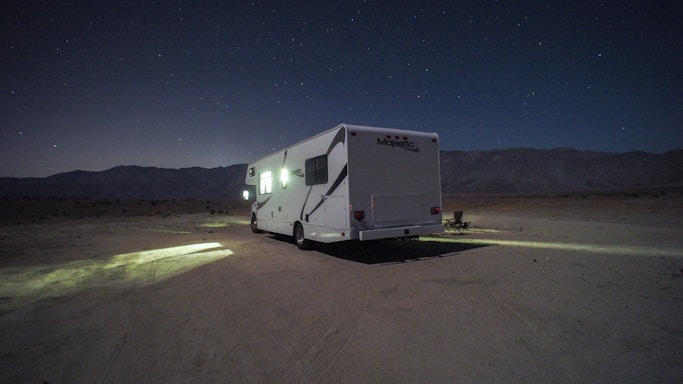 A cozy RV parked under a starry desert sky at Burning Man.