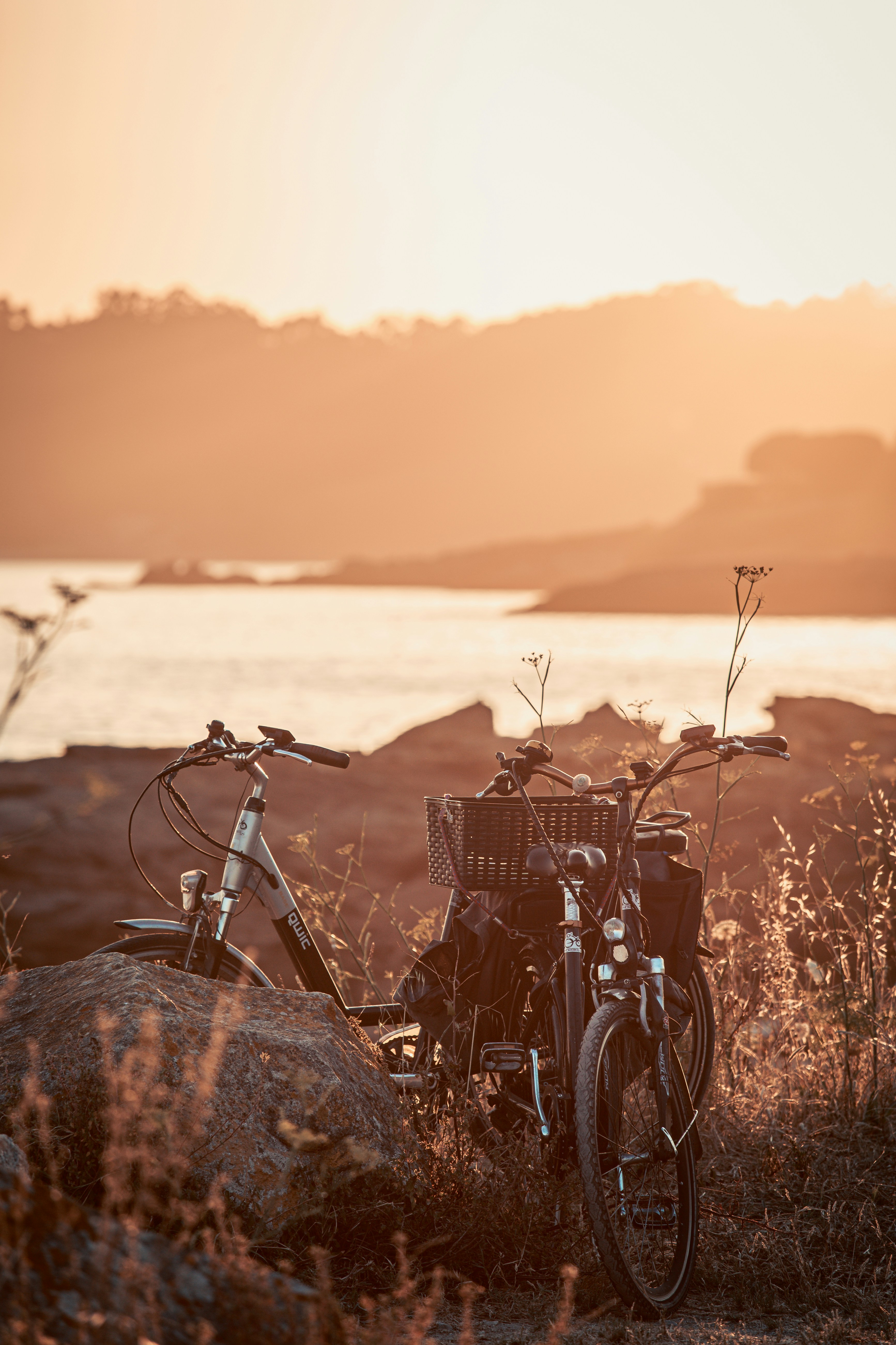 black bicycle on brown rock during sunset