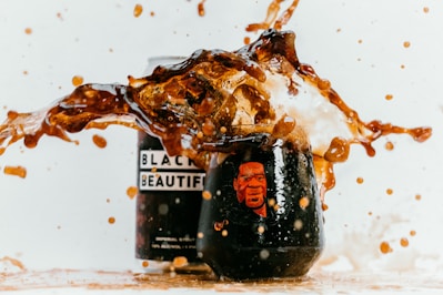 black and white ceramic mug with brown liquid