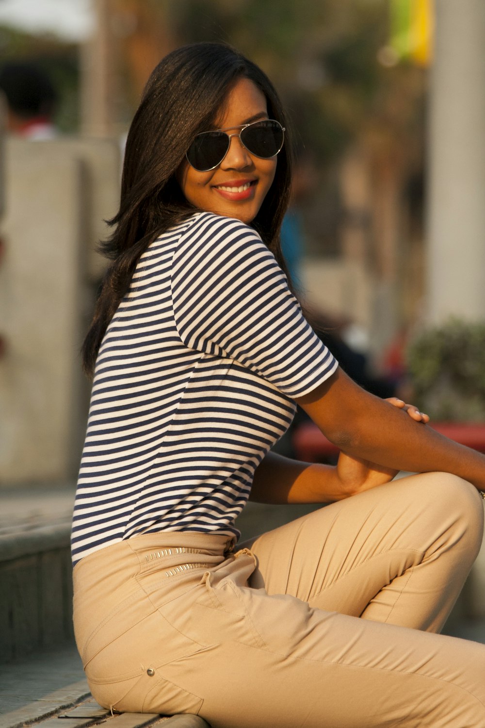 woman in black and white striped shirt and brown pants sitting on concrete  bench during daytime photo – Free Santo domingo Image on Unsplash