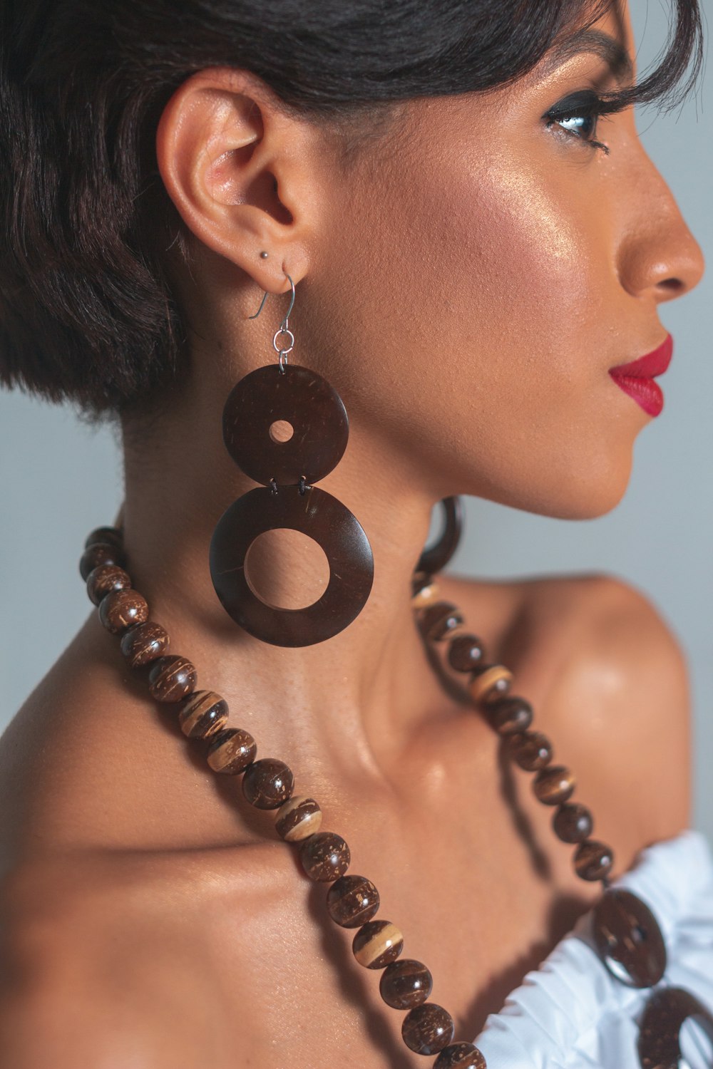 woman wearing black and gold beaded necklace