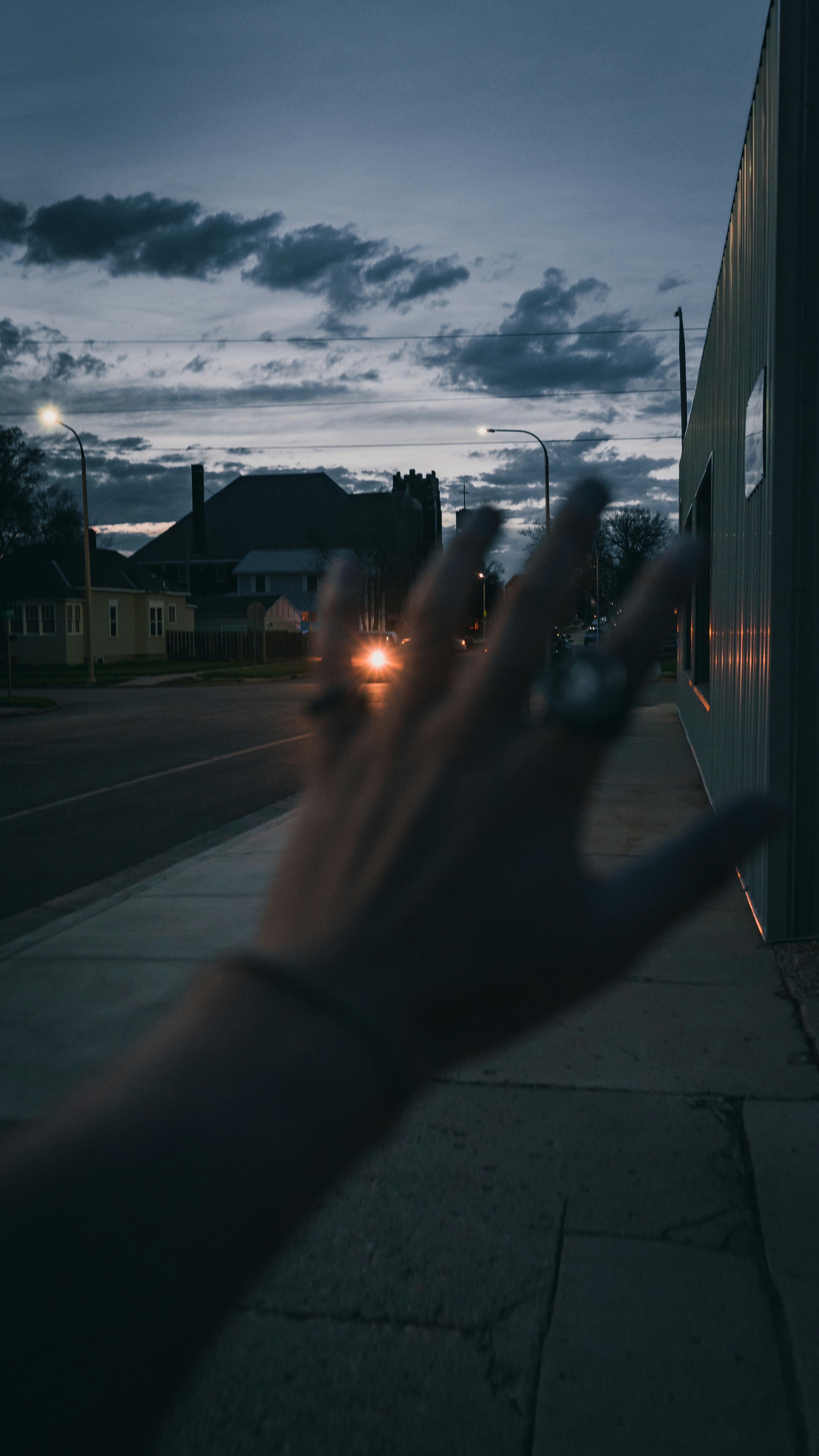 person standing on sidewalk during sunset