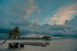 Sunlit hotel patio with vibrant blue bean bags overlooking a serene Bali beach.