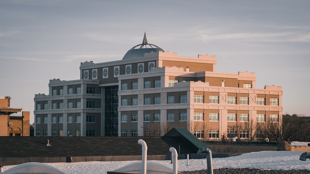 brown and white concrete building under white sky during daytime