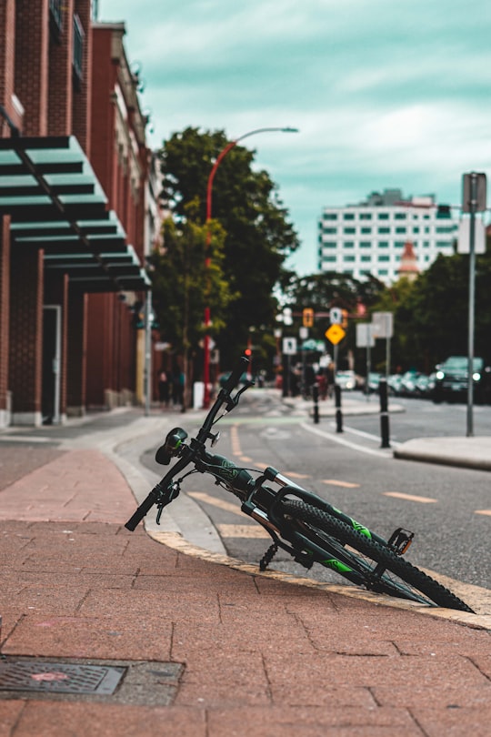 black bicycle parked on sidewalk during daytime in Fan Tan Alley Canada