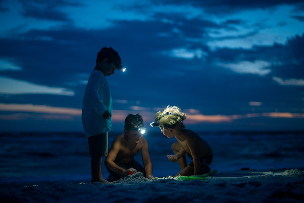 man in blue shirt and black shorts sitting on water with girl in black shorts during