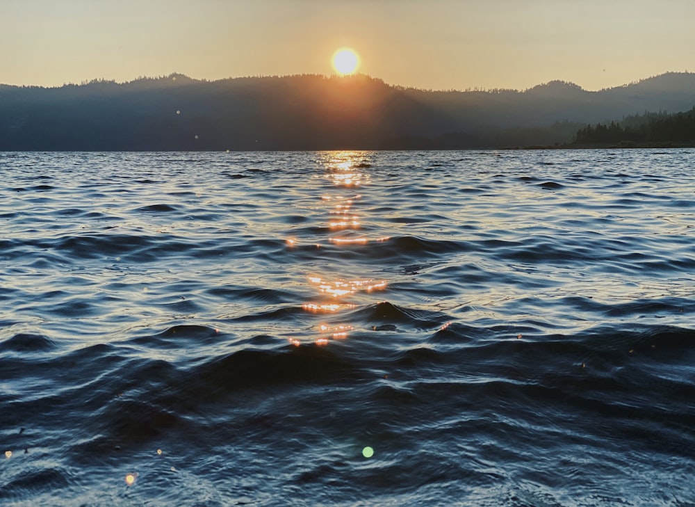 body of water during sunset