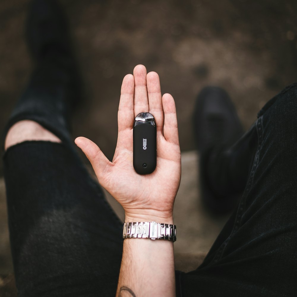 person holding black smartphone on left hand