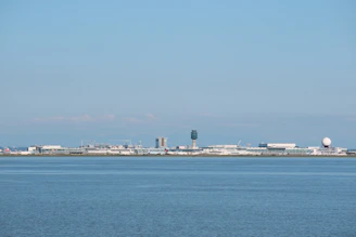 A panoramic view of a busy airport control tower overseeing orderly aircraft movements under a clear sky.