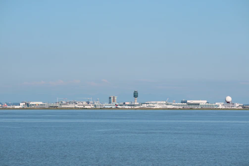 A panoramic view of a busy airport control tower overseeing orderly aircraft movements under a clear sky.