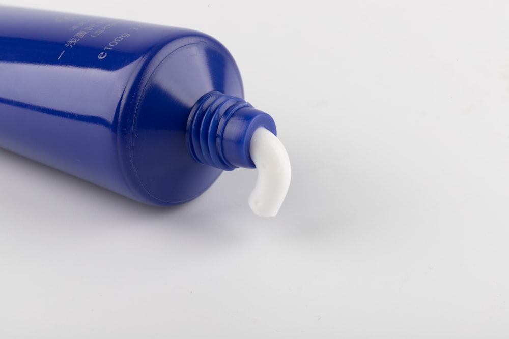blue and white plastic toothpaste tube