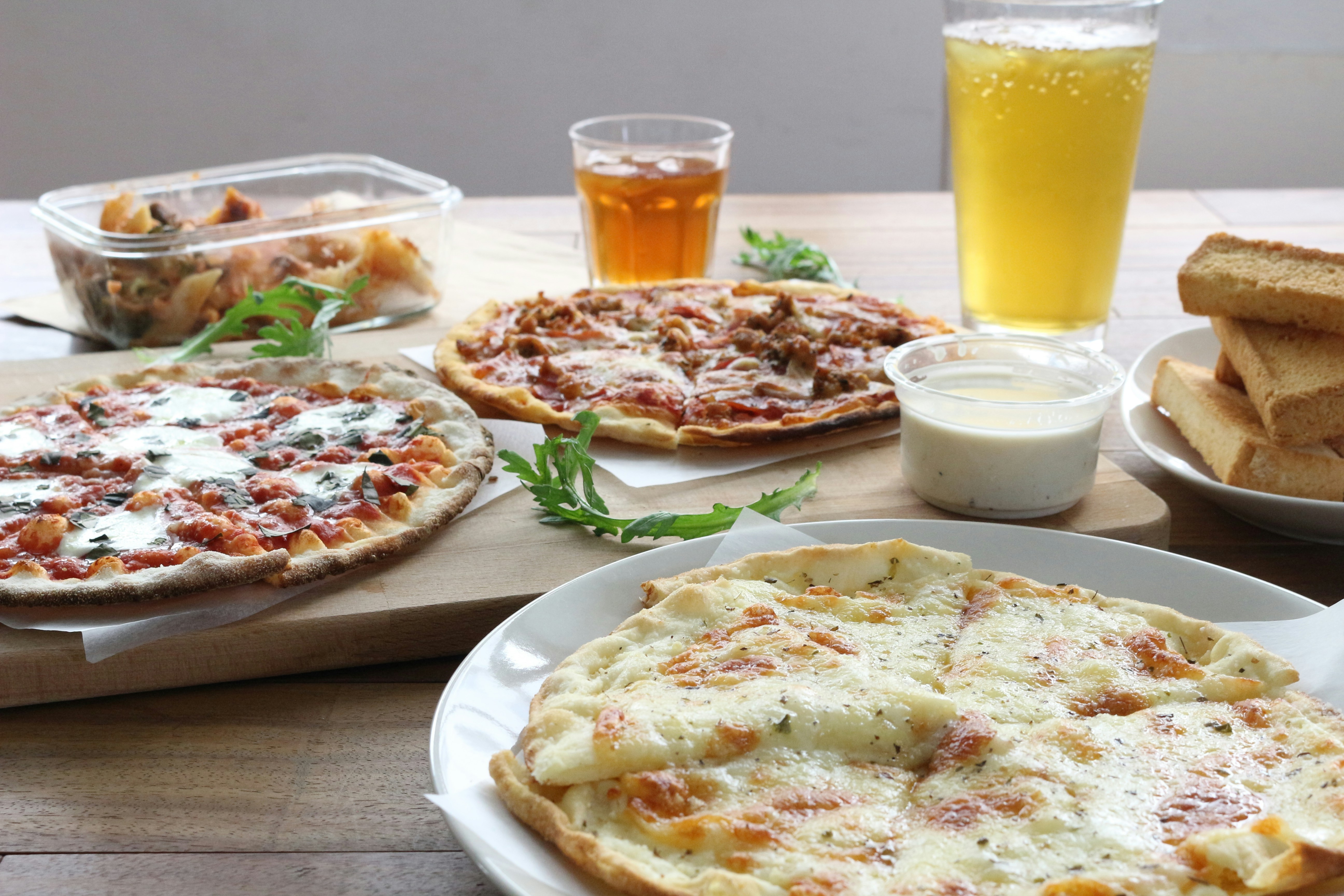 pizza on white ceramic plate beside drinking glass
