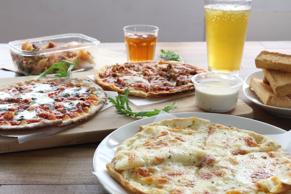 pizza on white ceramic plate beside drinking glass