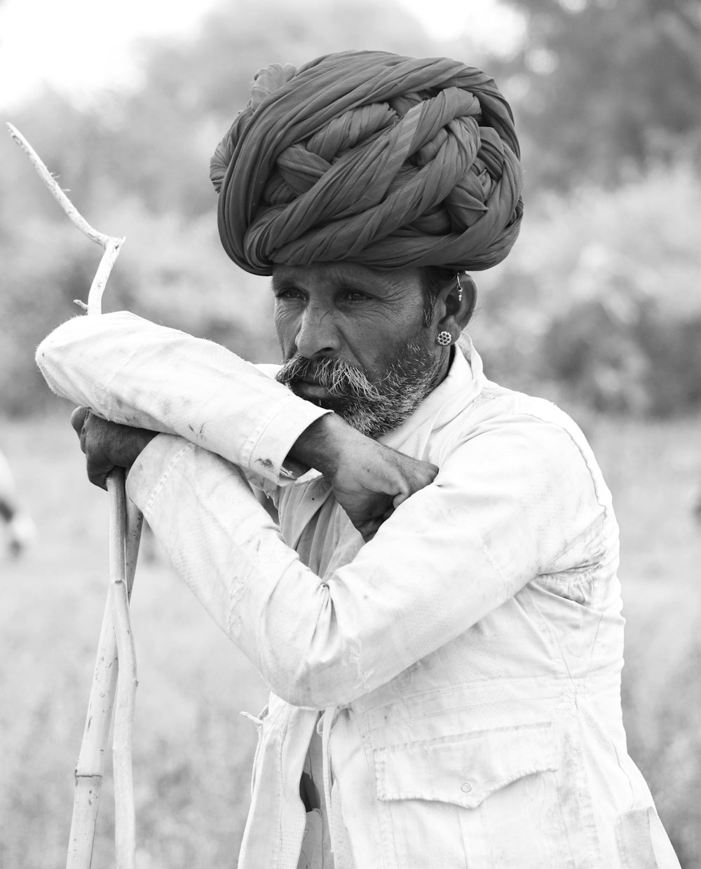 man in white dress shirt holding white textile