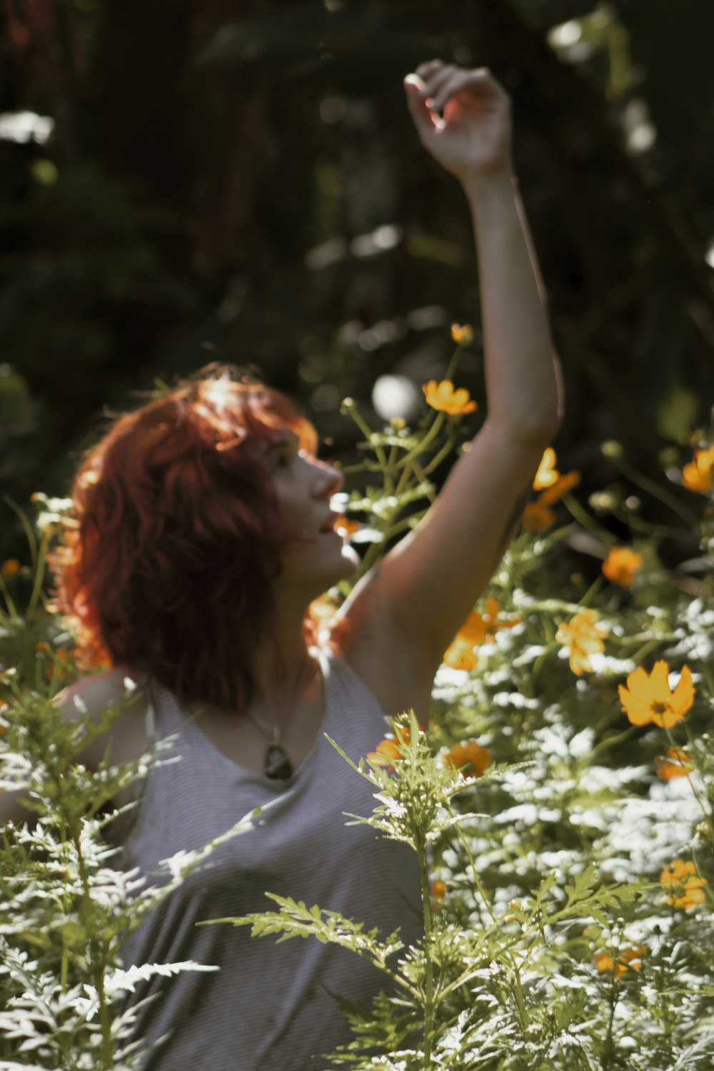 woman in white shirt standing on white flower field during daytime