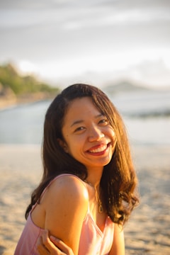 woman in white tank top smiling