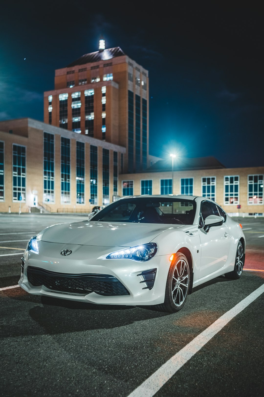 white porsche 911 parked on parking lot during night time