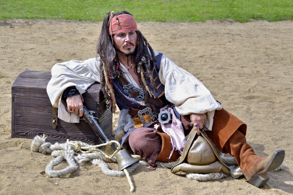 man in brown jacket and red cap sitting on brown horse during daytime