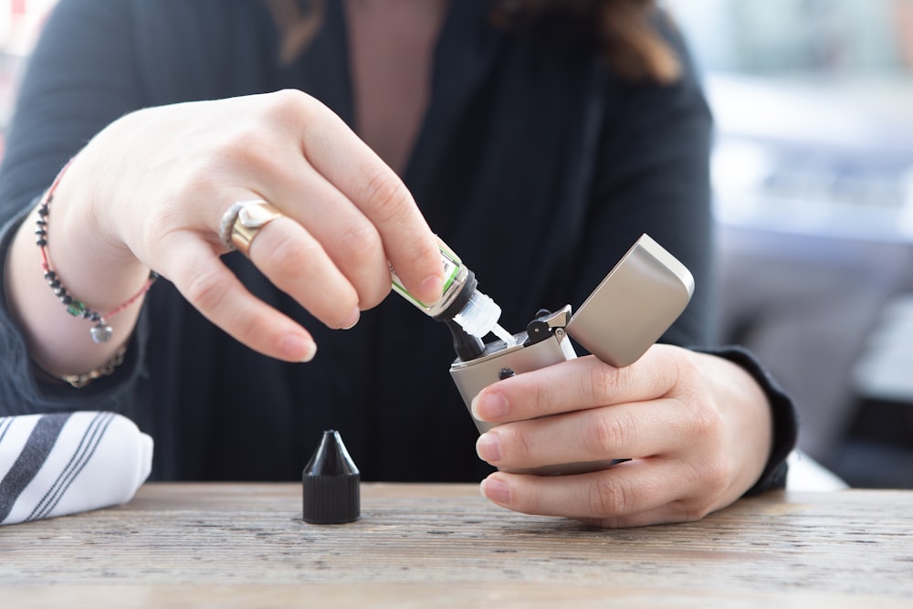 person holding silver flip lighter