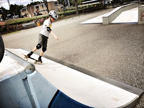 Young skater practicing balance on the smooth rink at Electronic City playground