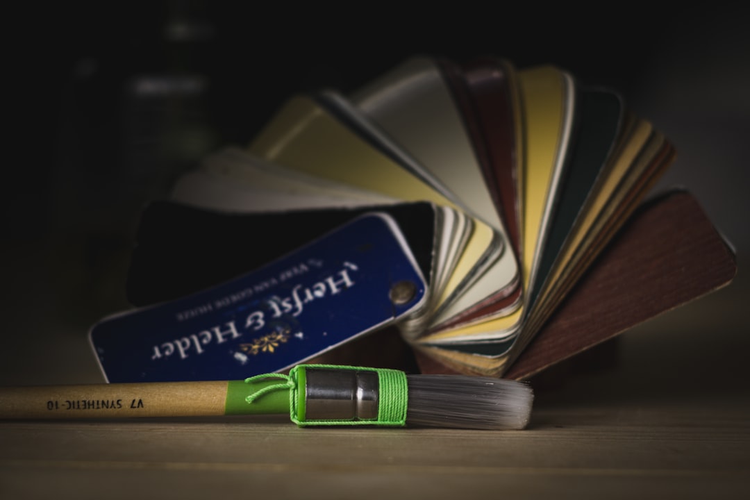 green and yellow pen beside black and white book
