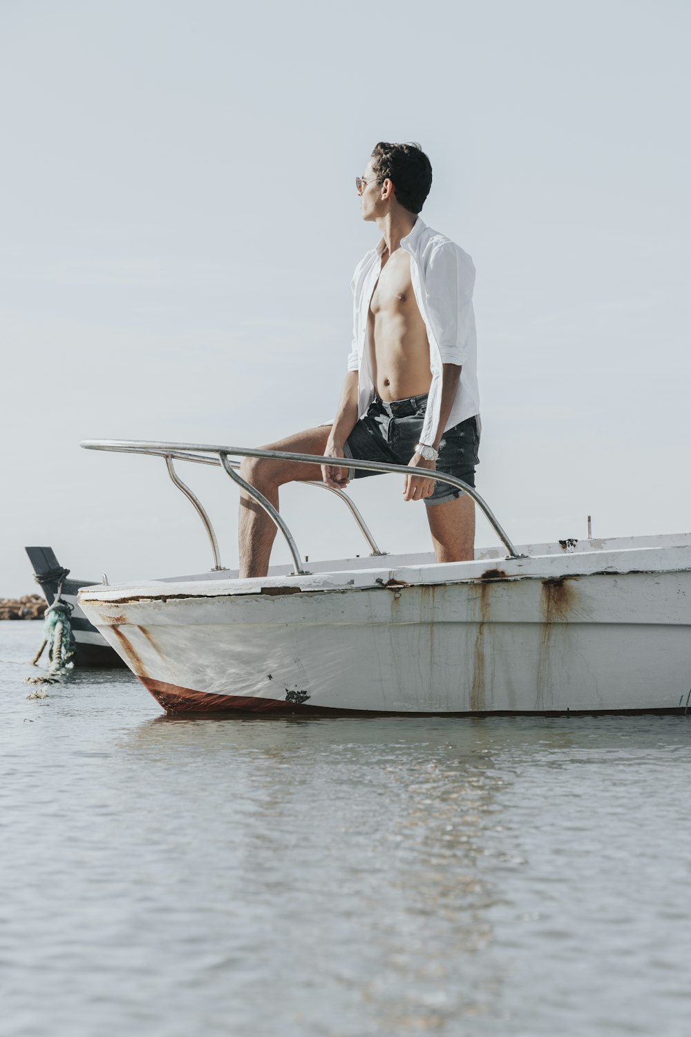 woman in white blazer standing on white boat during daytime