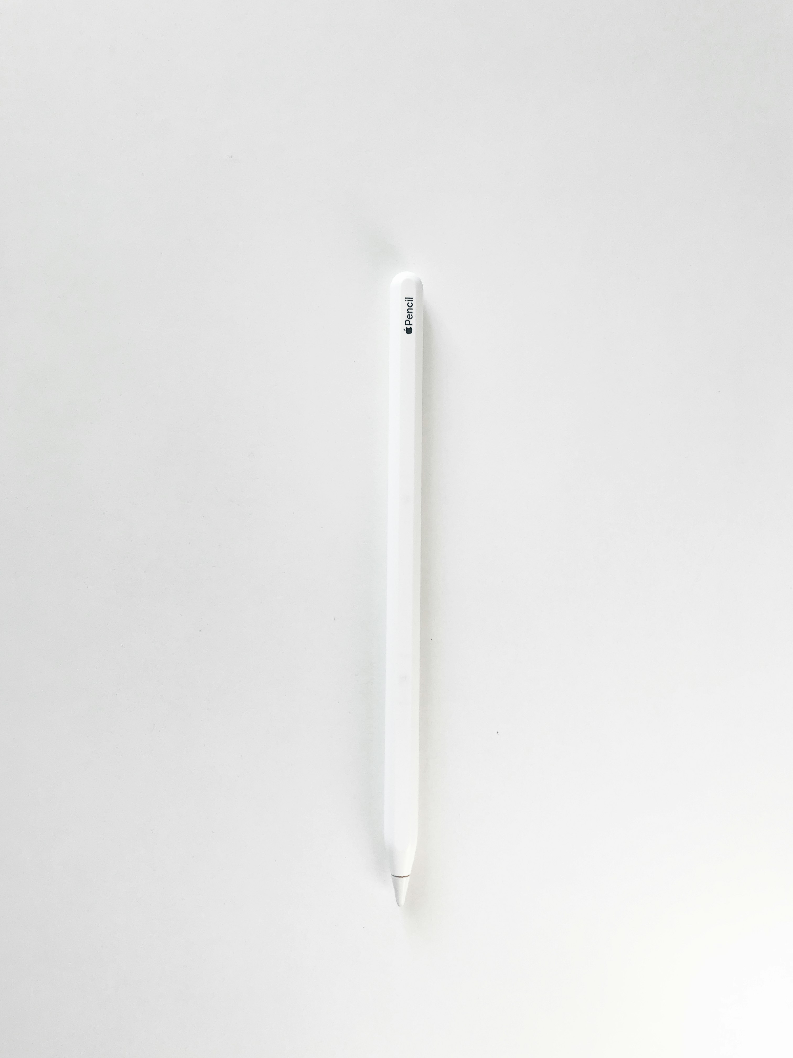 white pen on white surface