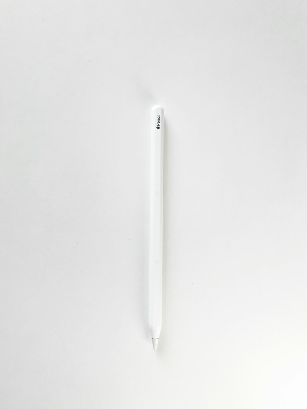 white pen on white surface