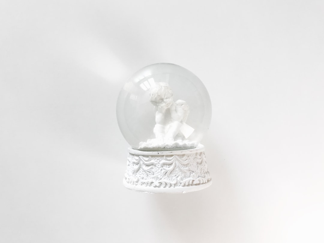white snow globe on white table