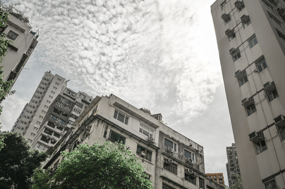 white concrete building under white clouds during daytime