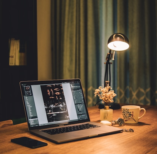 macbook pro on brown wooden table